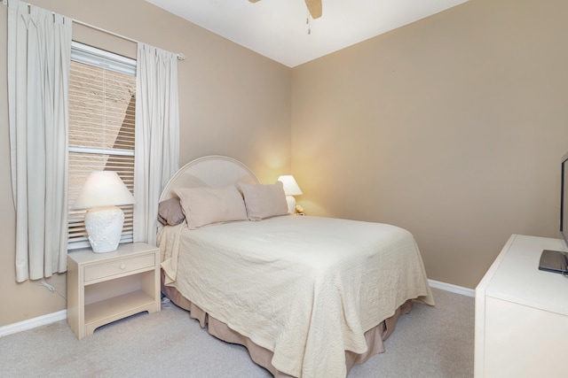 bedroom with ceiling fan and light colored carpet