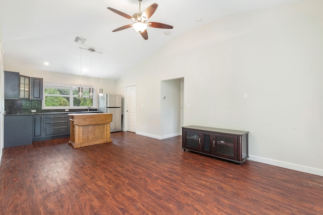 kitchen with ceiling fan, hanging light fixtures, gray cabinetry, dark wood-type flooring, and stainless steel refrigerator