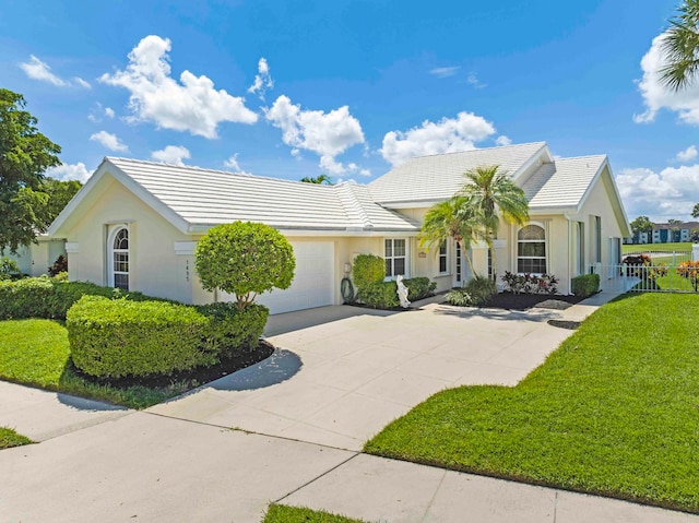 single story home with a garage and a front lawn