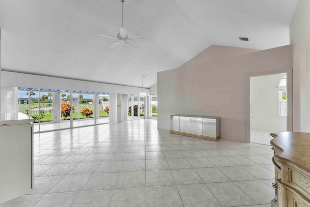 living room featuring ceiling fan, light tile patterned flooring, and lofted ceiling