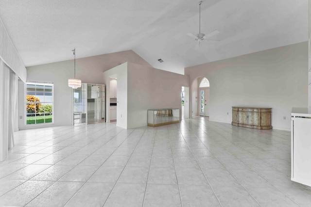 unfurnished living room featuring light tile patterned flooring, ceiling fan, and high vaulted ceiling