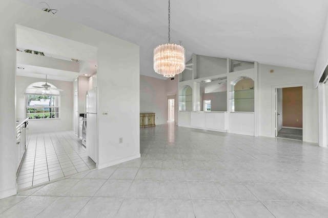 tiled empty room featuring ceiling fan with notable chandelier and vaulted ceiling