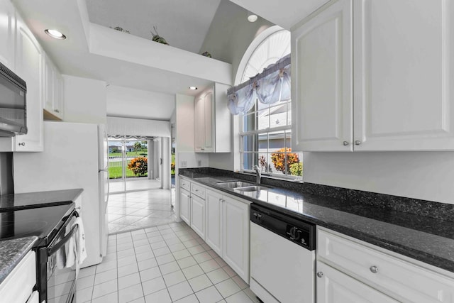 kitchen with light tile patterned flooring, white cabinetry, black appliances, dark stone counters, and sink