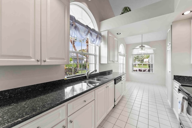 kitchen featuring ceiling fan, white cabinets, sink, and a wealth of natural light