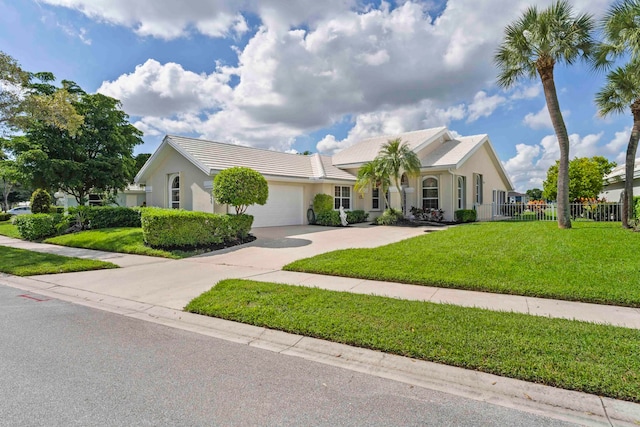 view of front of property featuring a garage and a front yard