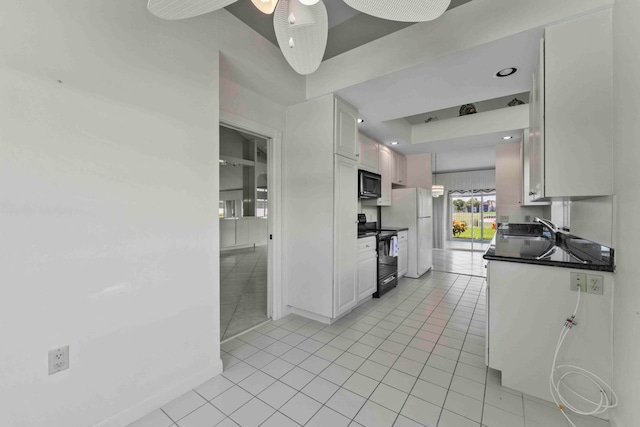 kitchen with ceiling fan, white cabinets, light tile patterned floors, sink, and black appliances