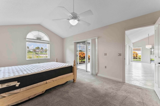 carpeted bedroom featuring lofted ceiling, multiple windows, access to exterior, and ceiling fan