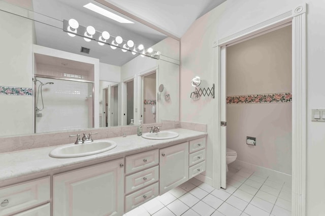 bathroom with tile patterned flooring, vanity, toilet, and a shower with shower door