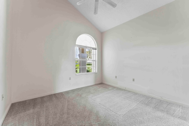 spare room featuring ceiling fan, a textured ceiling, light carpet, and vaulted ceiling