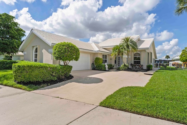 view of front facade featuring a garage and a front lawn