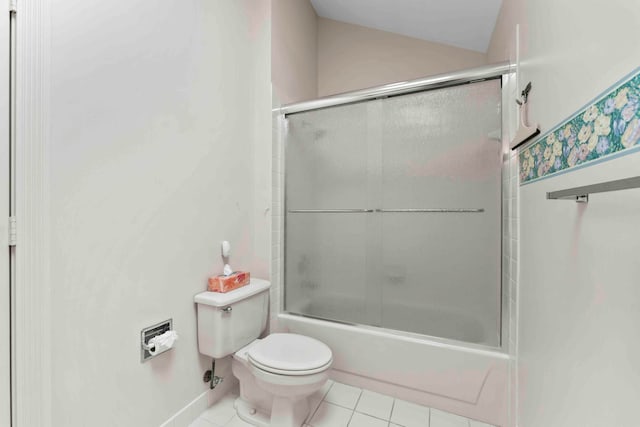 bathroom featuring bath / shower combo with glass door, toilet, and tile patterned floors