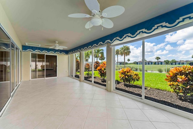 unfurnished sunroom with ceiling fan