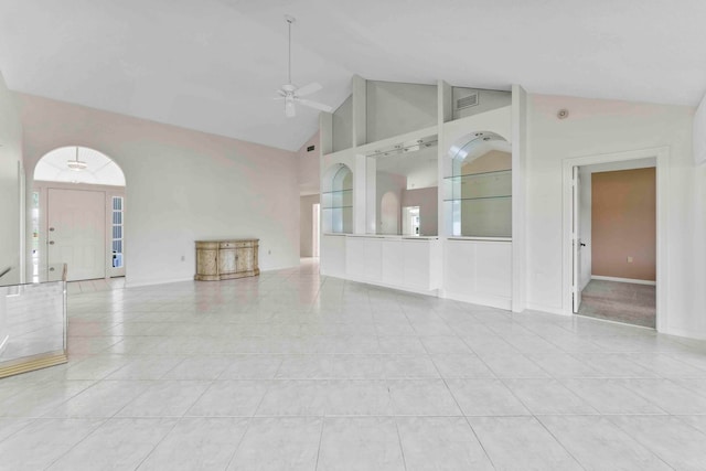 unfurnished living room featuring light tile patterned floors, ceiling fan, and high vaulted ceiling