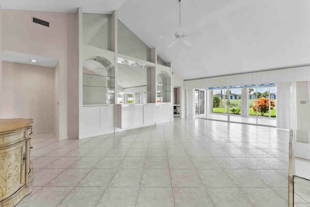 unfurnished living room with high vaulted ceiling, ceiling fan, and light tile patterned floors