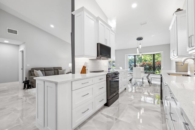 kitchen featuring black appliances, vaulted ceiling, sink, and white cabinetry