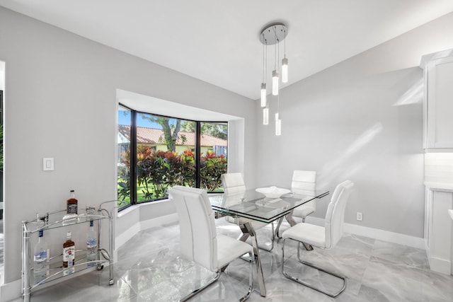 dining room featuring vaulted ceiling