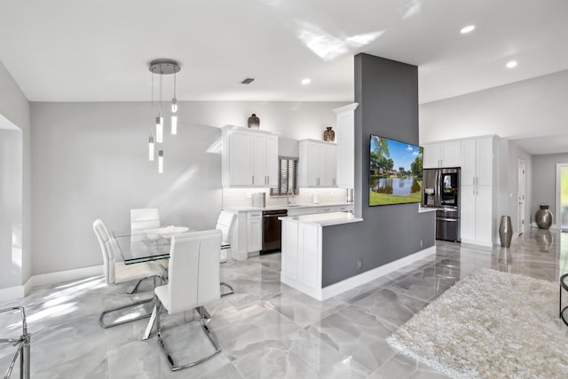 dining room featuring sink and high vaulted ceiling