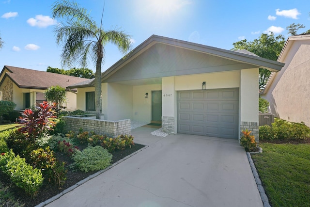 ranch-style house featuring cooling unit and a garage