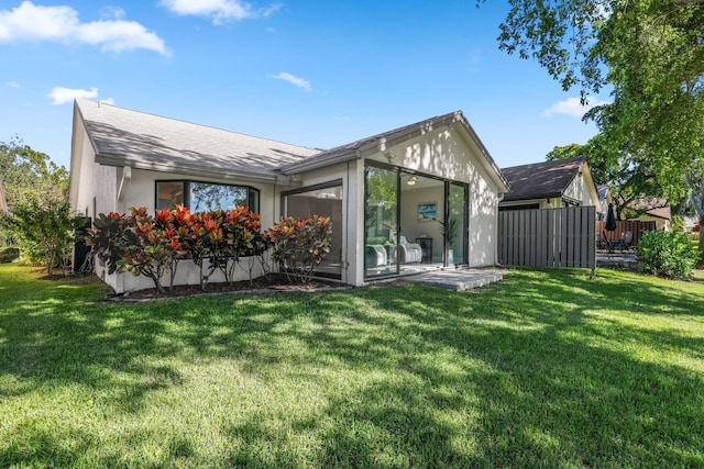 rear view of property with a yard and a patio