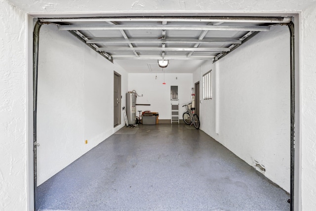 garage with electric water heater and a garage door opener