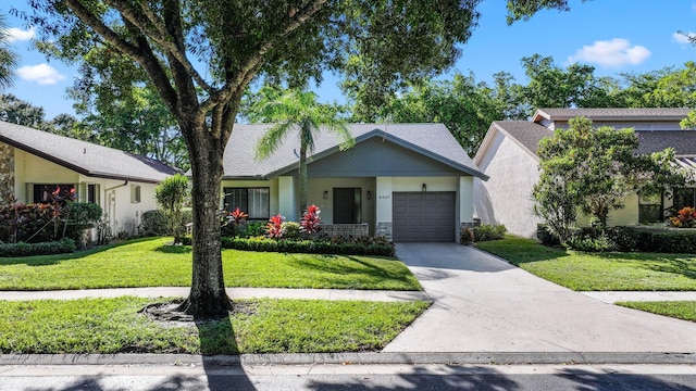 view of front of house featuring a front lawn and a garage