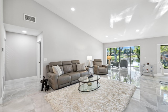 living room with high vaulted ceiling