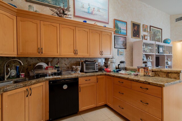 kitchen featuring black dishwasher, kitchen peninsula, light stone countertops, light tile patterned floors, and sink