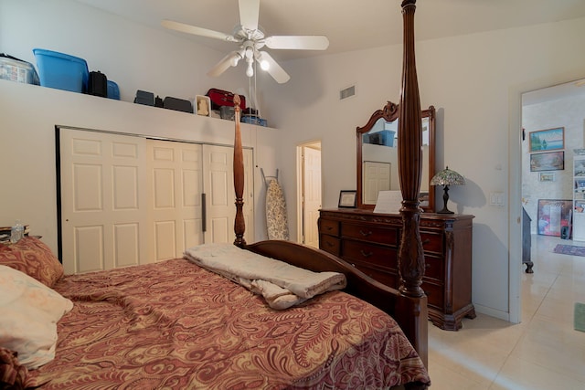 bedroom featuring ceiling fan, a closet, light tile patterned floors, and high vaulted ceiling