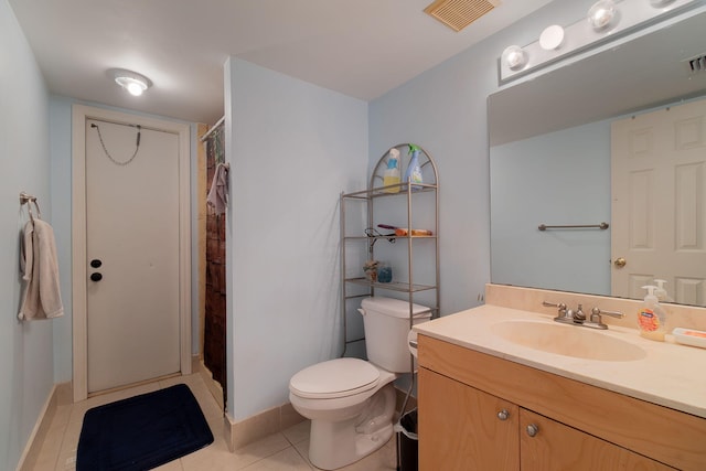 bathroom featuring walk in shower, vanity, toilet, and tile patterned floors