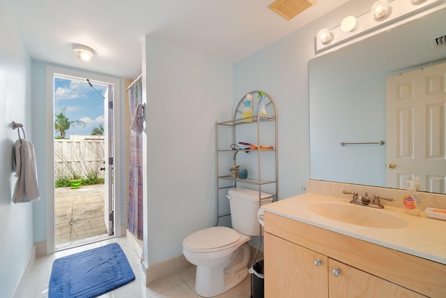 bathroom with vanity, toilet, a shower with shower curtain, and tile patterned floors