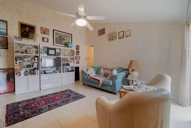 tiled living room with ceiling fan, built in features, and high vaulted ceiling