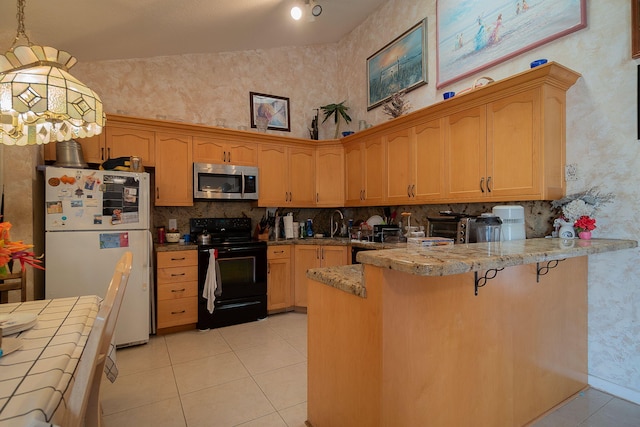 kitchen featuring black / electric stove, kitchen peninsula, light tile patterned floors, white fridge, and decorative light fixtures