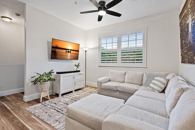 living room featuring ceiling fan and light wood-type flooring