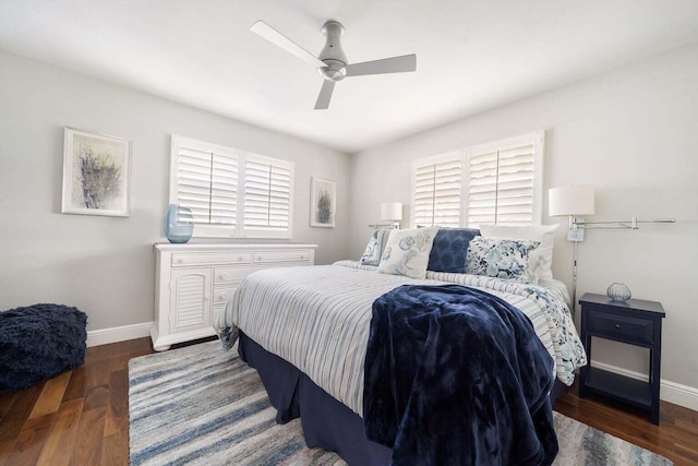 bedroom with ceiling fan, multiple windows, and dark hardwood / wood-style flooring