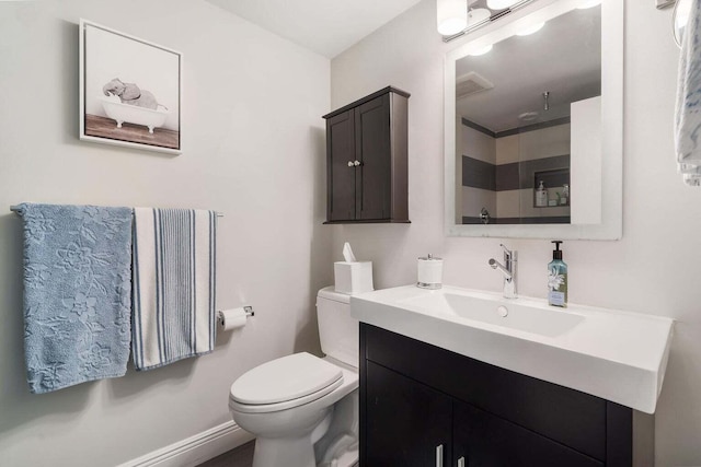 bathroom with vanity, toilet, and walk in shower