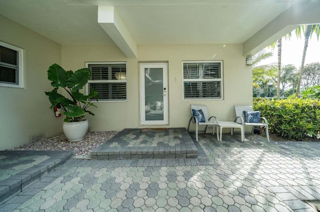 entrance to property featuring a patio