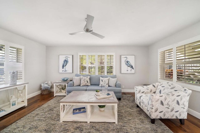 living room with dark wood-type flooring and ceiling fan