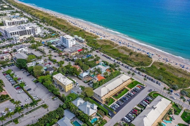 birds eye view of property featuring a view of the beach and a water view