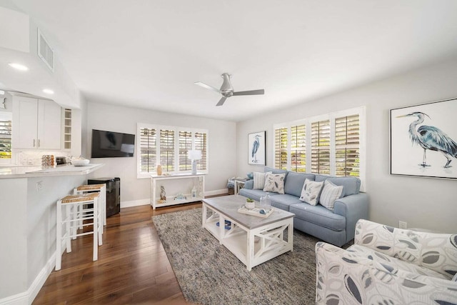 living room featuring dark hardwood / wood-style floors and ceiling fan