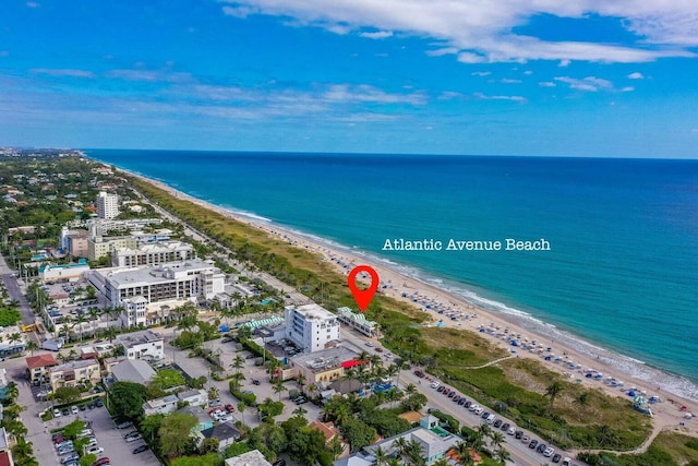 aerial view featuring a water view and a beach view