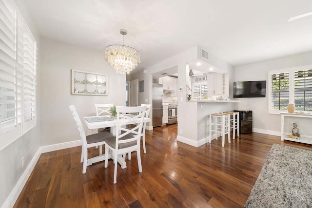 dining room featuring dark wood-type flooring and a notable chandelier