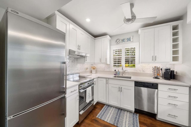 kitchen with tasteful backsplash, appliances with stainless steel finishes, sink, dark hardwood / wood-style flooring, and white cabinetry