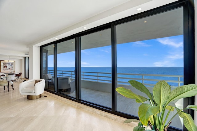 interior space featuring floor to ceiling windows and a water view