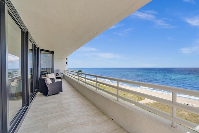 balcony with a view of the beach and a water view