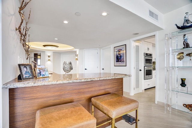 kitchen featuring white cabinetry, kitchen peninsula, and appliances with stainless steel finishes