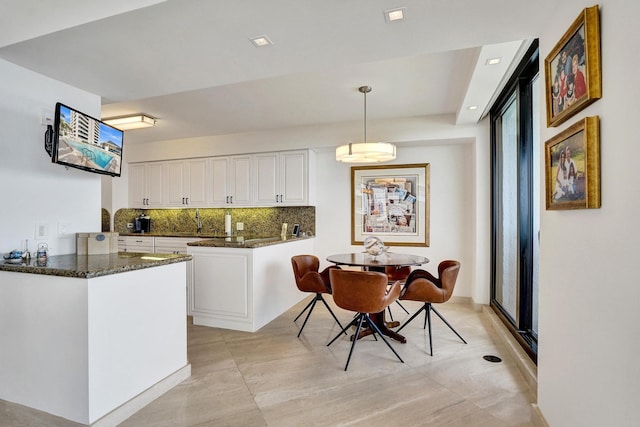 dining area featuring floor to ceiling windows, a water view, and a healthy amount of sunlight