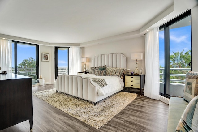 bedroom with hardwood / wood-style floors and multiple windows