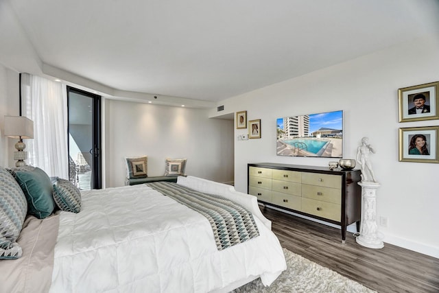 bedroom featuring wood-type flooring and access to exterior