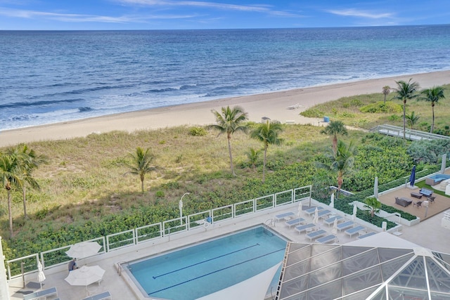 view of pool featuring a view of the beach and a water view