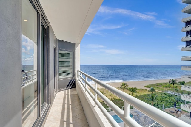 balcony featuring a water view and a beach view